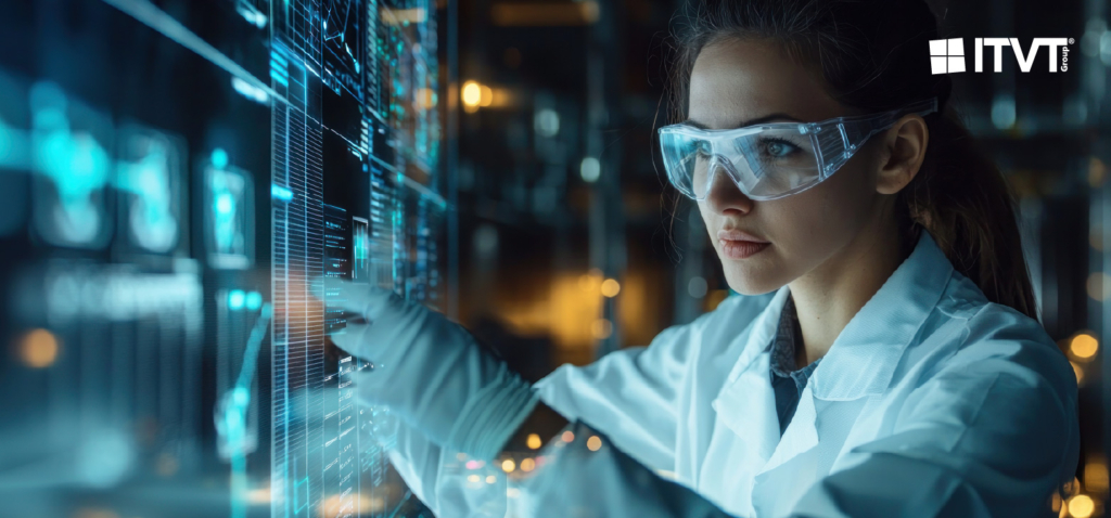 A woman in a lab coat studies a computer screen and concentrates on her work in a scientific environment.